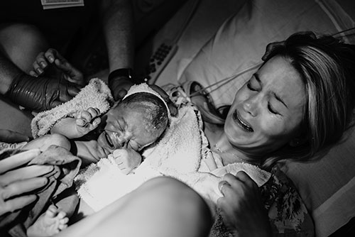 Mother cries holding her baby for the first time in Portland Oregon