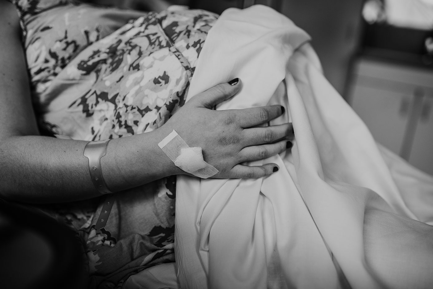 mom's hand on her stomach during a contraction during birth