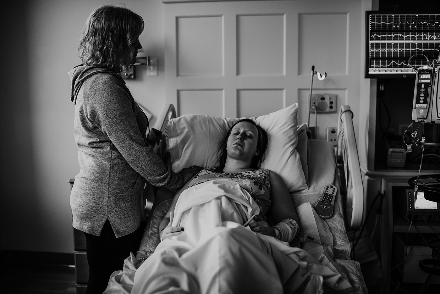 mother touches her daughter's shoulder during birth at Portland Good Sam hospital