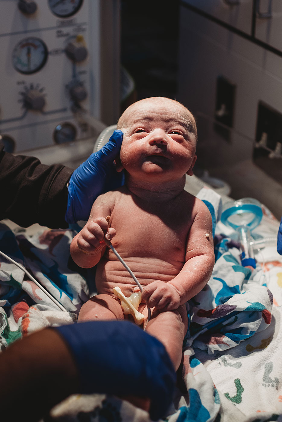 newborn baby boy opening his eyes