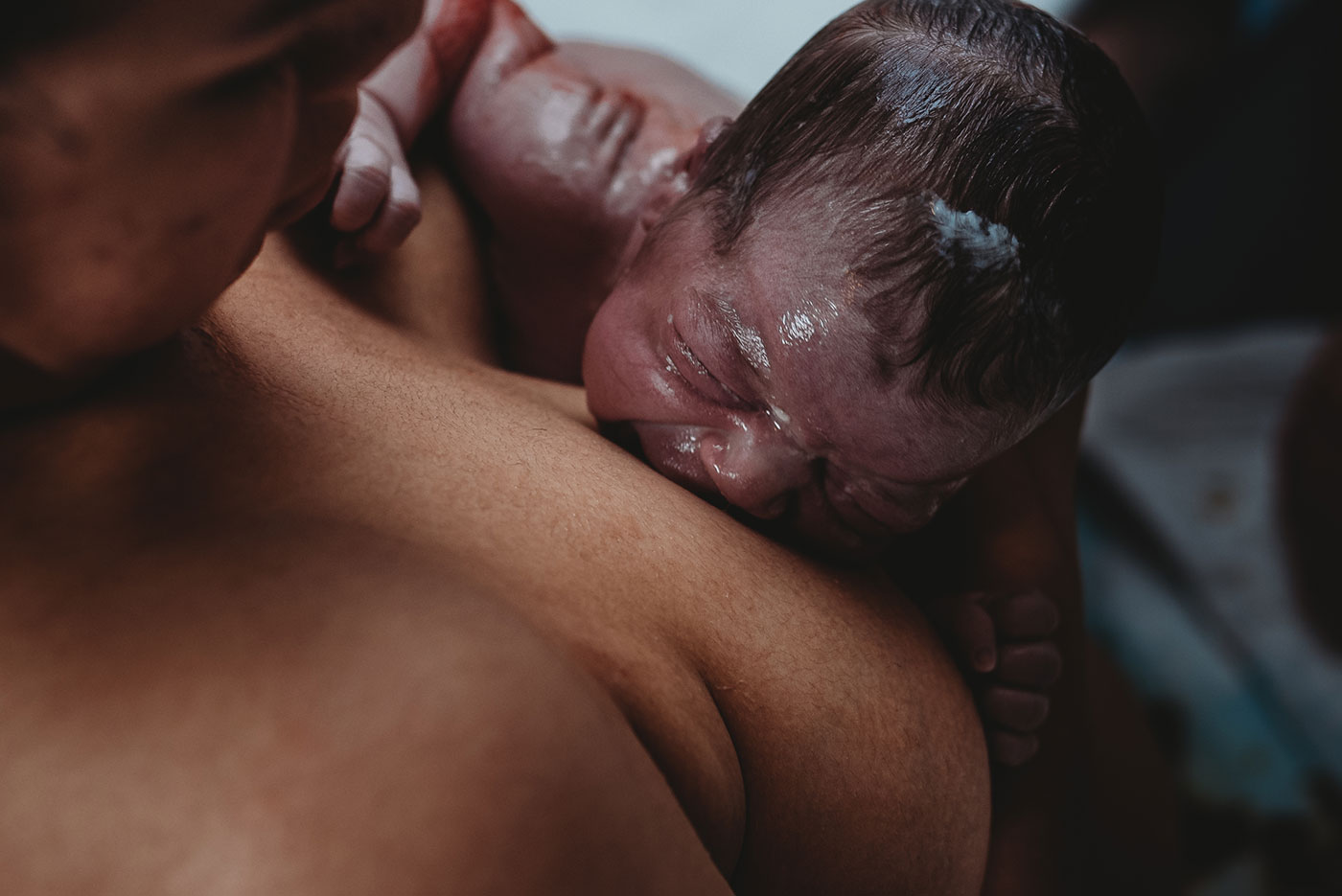 baby cries on her mother's breast after being born at home