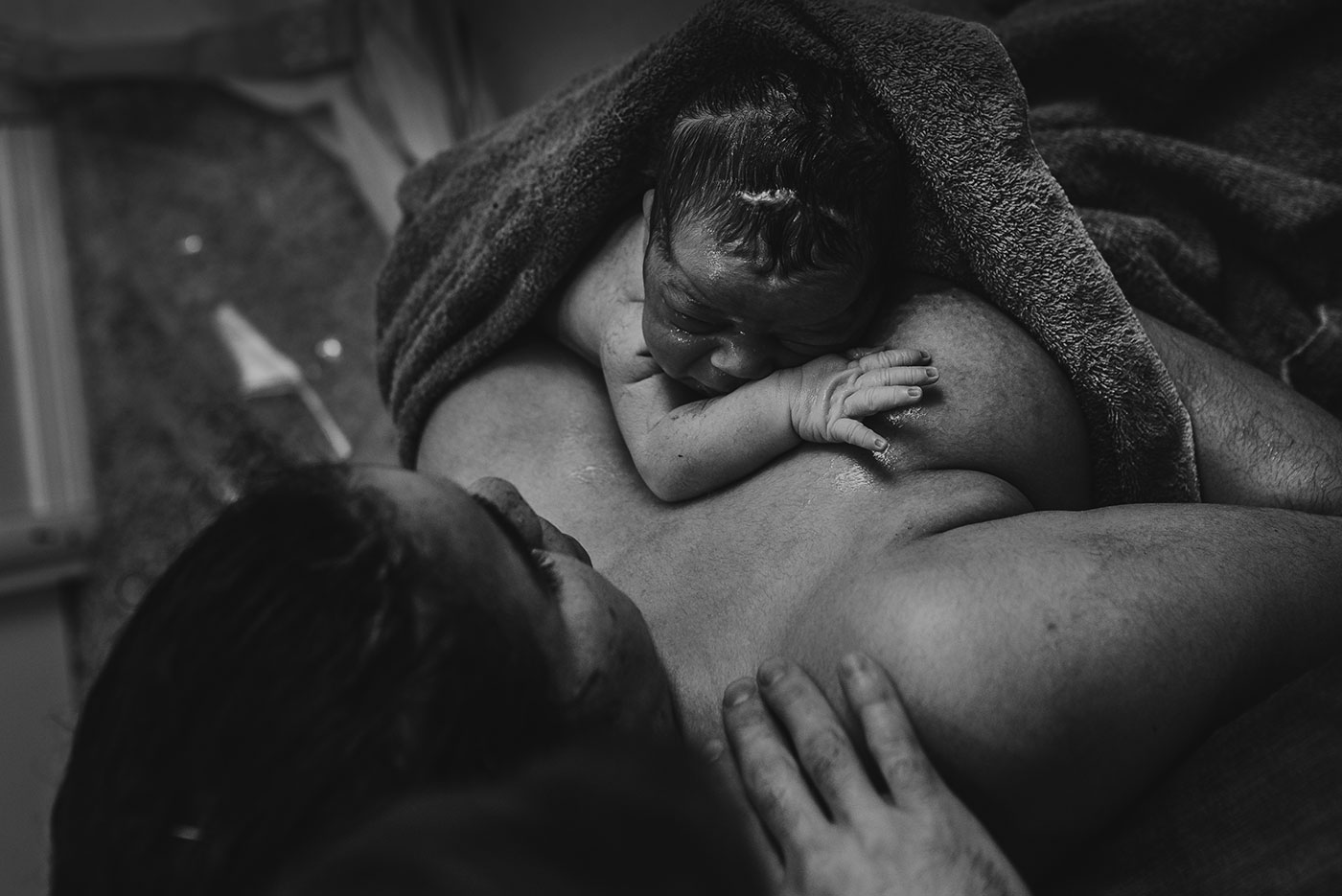 wet baby on mother's chest immediately after birth at home