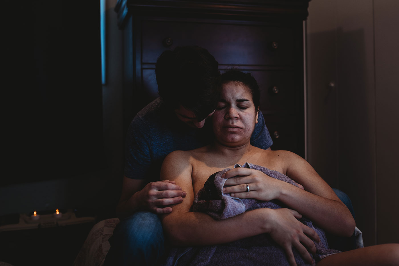 mom closes her eyes holding her baby, home birth photography in Portland